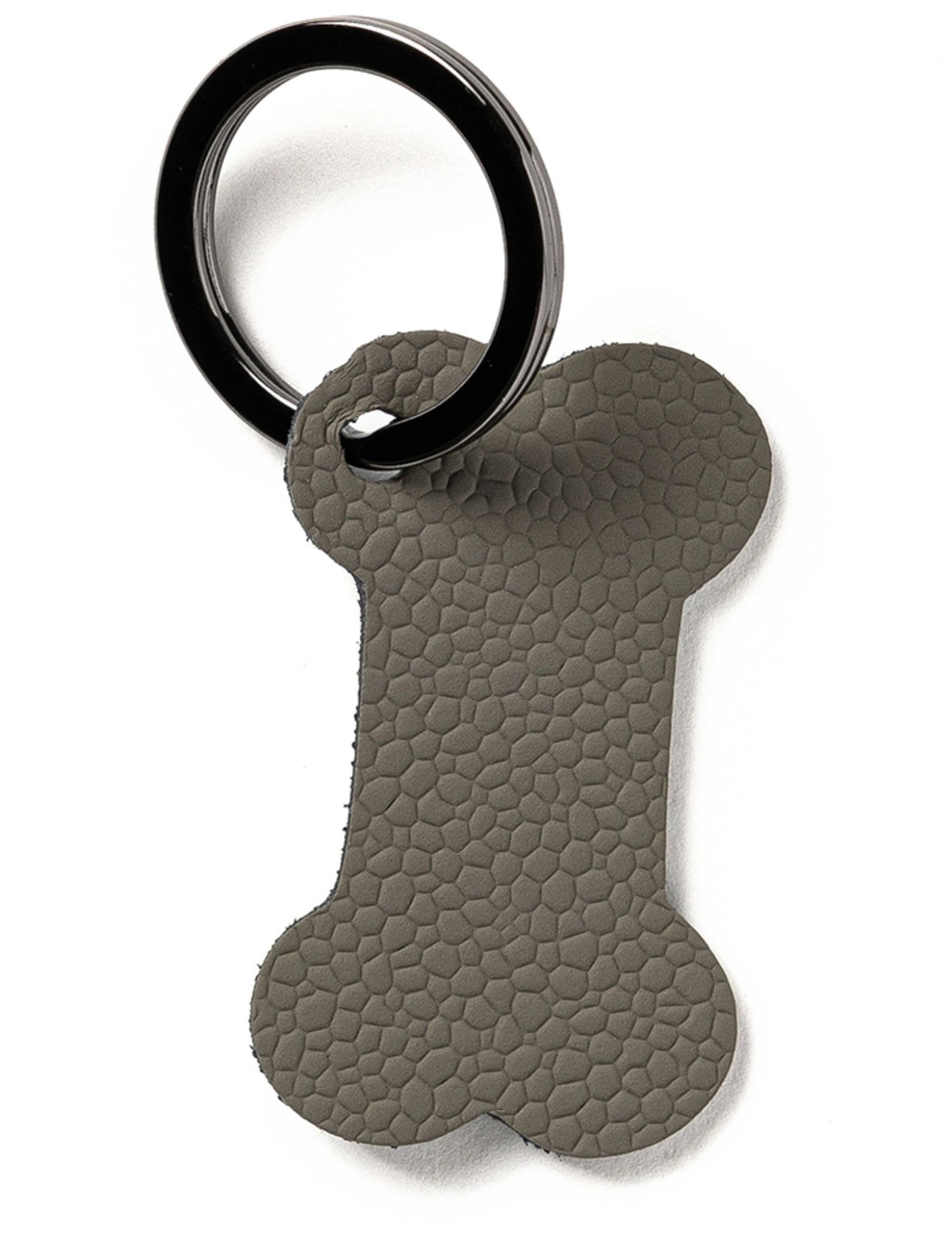 Grauer Schlüsselanhänger in Form eines Hundeknochens, kompakte Grösse, von MiLLE W NORDISK DESIGN, flach und leicht.