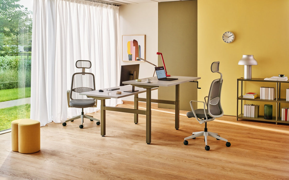 Doppelschreibtisch Ogi Drive Bench von Mdd mit Tischplatte in Honigeiche, schwarzem Metallgestell und seitlicher Kurbel zur Höhenverstellung.
