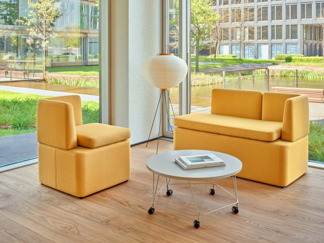 Niedriges modulares Sofa Kaiva von Mdd in Dunkelgrau mit gepolstertem Holzrahmen und geometrischer Rückenlehne, freigestellt.