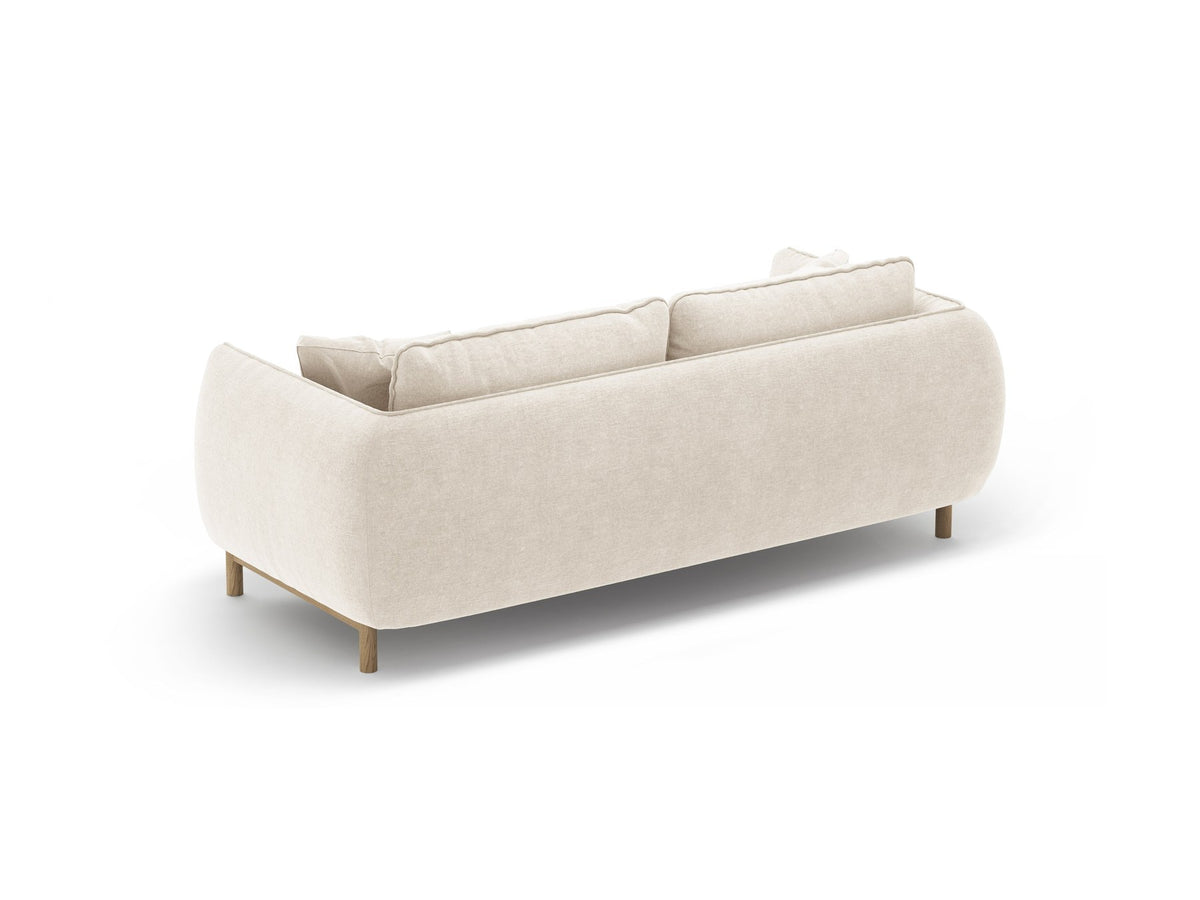 Ada 2er Sofa von Micadoni in Mandel beige mit gepolstertem Velours-Bezug, geschwungener Rückenlehne und sichtbaren Buchenholzbeinen.
