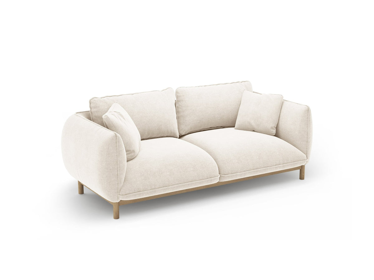 Ada 2er Sofa von Micadoni in Mandel beige mit gepolstertem Velours-Bezug, geschwungener Rückenlehne und sichtbaren Buchenholzbeinen.