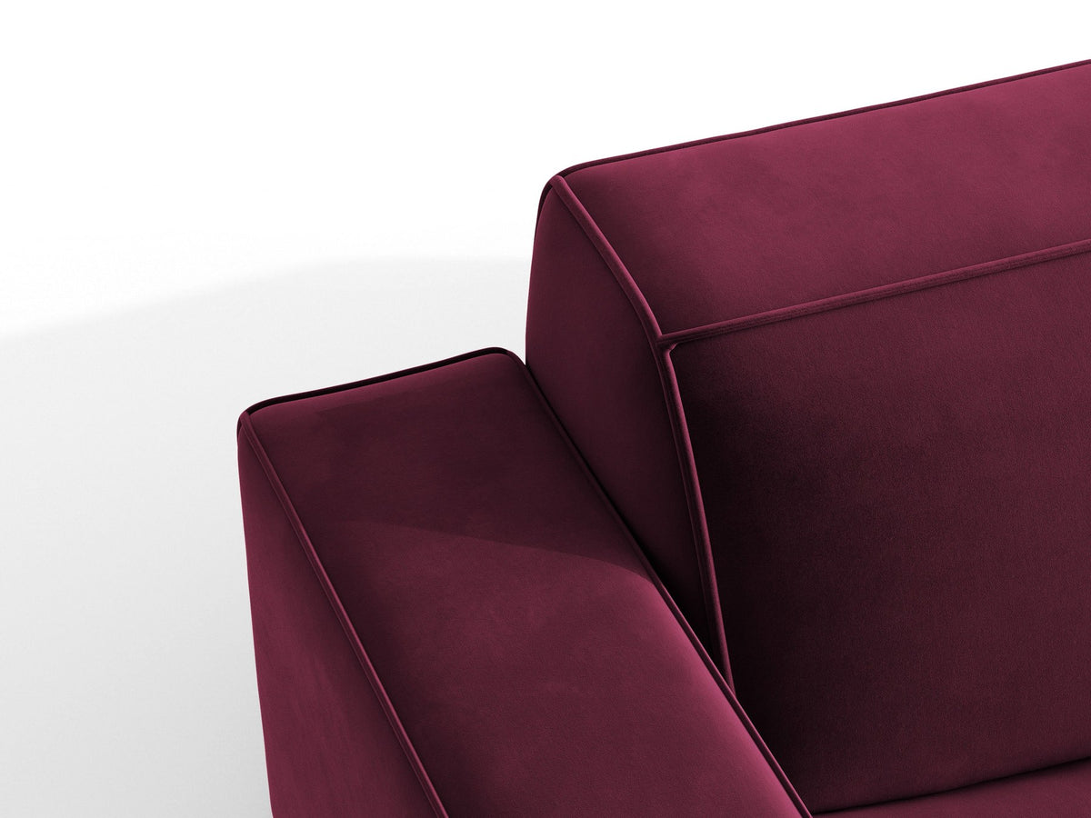 Zweisitzer-Sofa Jodie von Micadoni mit beigem Samtbezug, schwarzen Kunststoffbeinen und gepolsterter Rückenlehne, Frontalansicht.