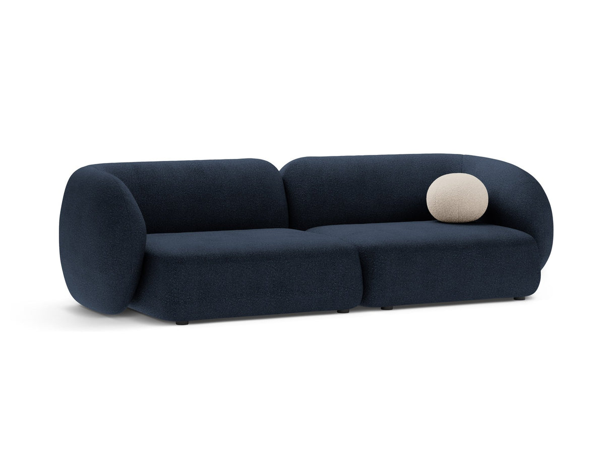 Weisses 4er Sofa Kate von Micadoni mit strukturiertem Bouclé-Stoff, schwarzen Kunststoffbeinen und breiter Sitzfläche.