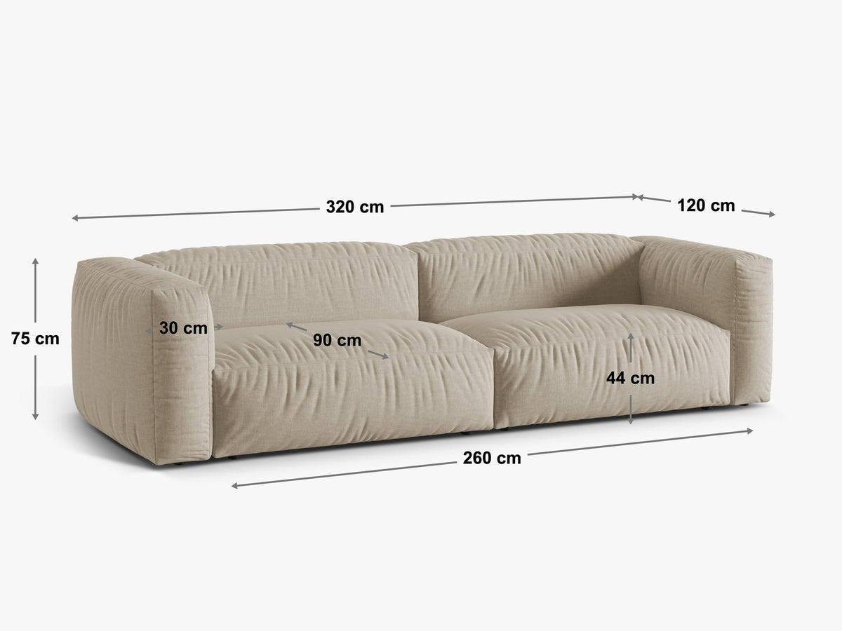 Modulares 4er Sofa Martina XL von Micadoni in Schokolade, Veloursstoff Vogue, schwarze Kunststoffbeine, im Wohnzimmer platziert.