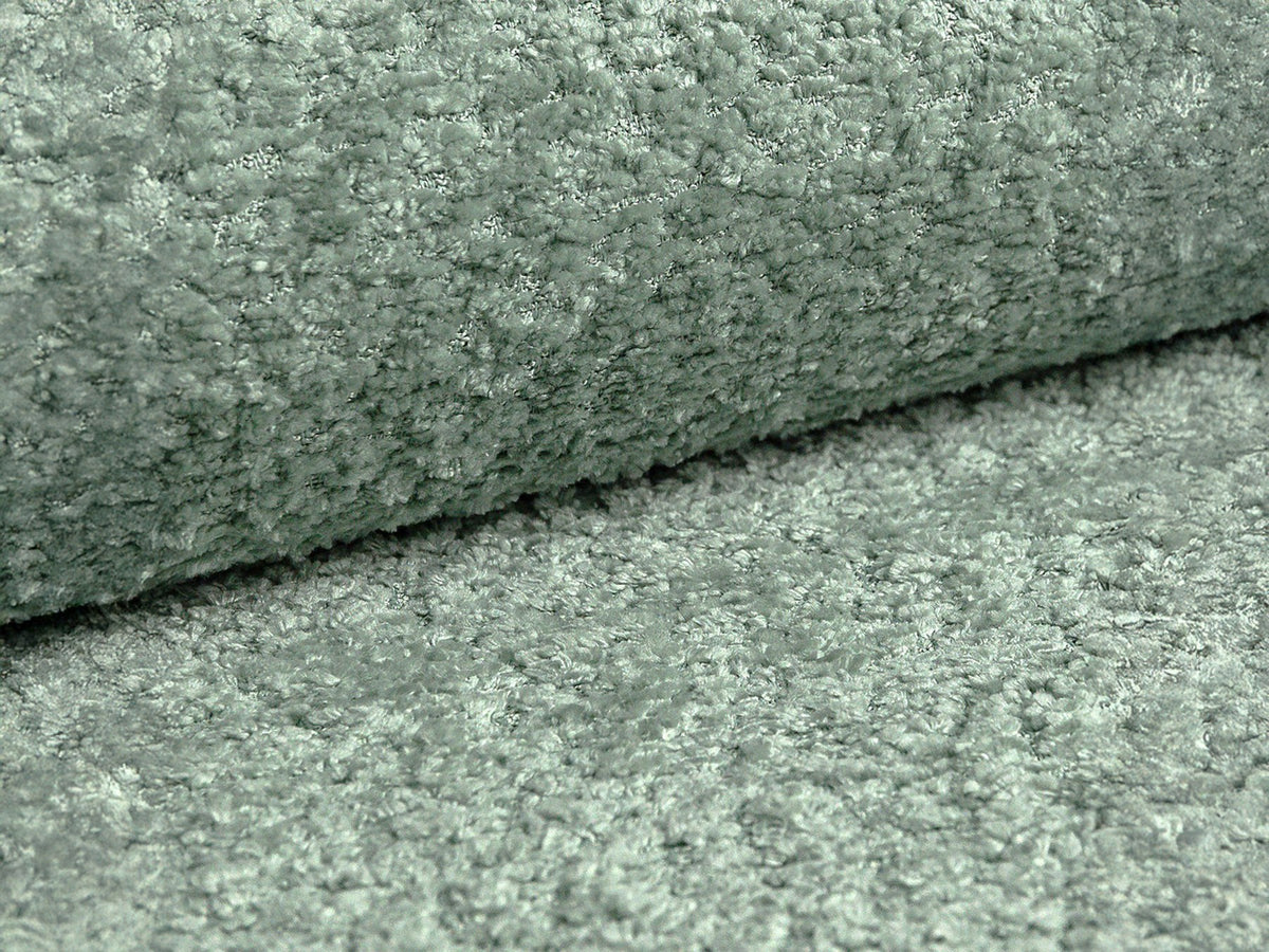 Beige Armsessel Abby von Micadoni mit strukturiertem Heritage-Stoffbezug, schwarzen Kunststoffbeinen und runder, kompakter Formgebung.