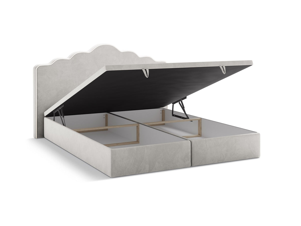 Polsterbett Dream mit hohem gepolstertem Kopfteil, elfenbeinfarbener Samtstoff-Bezug, schwarze Kunststoffbeine und Bettkasten mit Stauraum.
