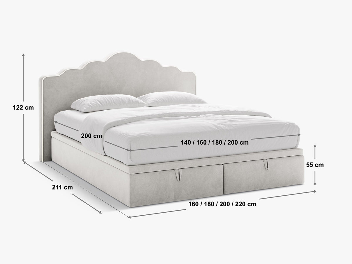 Polsterbett Dream mit hohem gepolstertem Kopfteil, elfenbeinfarbener Samtstoff-Bezug, schwarze Kunststoffbeine und Bettkasten mit Stauraum.