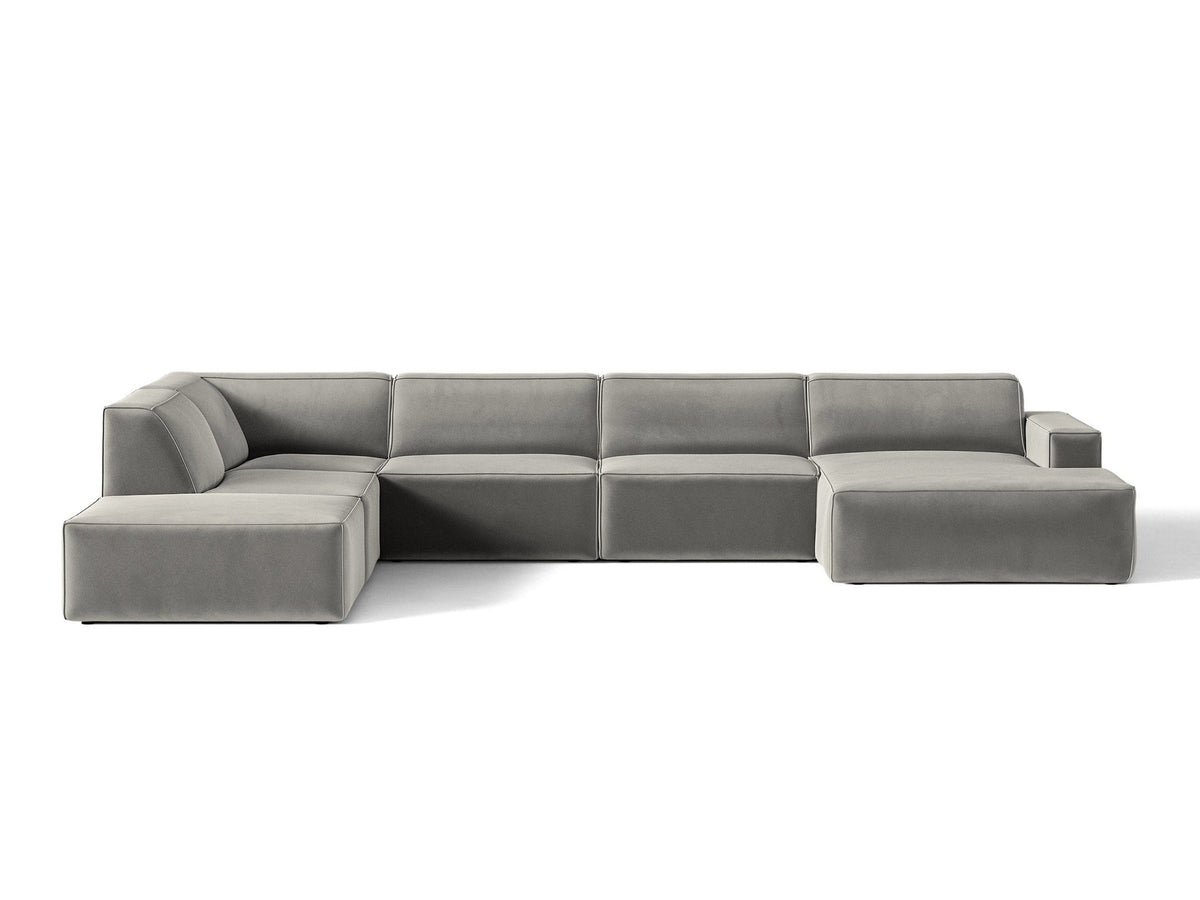 Modulares Ecksofa links Jodie von Micadoni in leichtem Beige mit Venus-Samtstoff, schwarzen Kunststoffbeinen und Panoramaform.