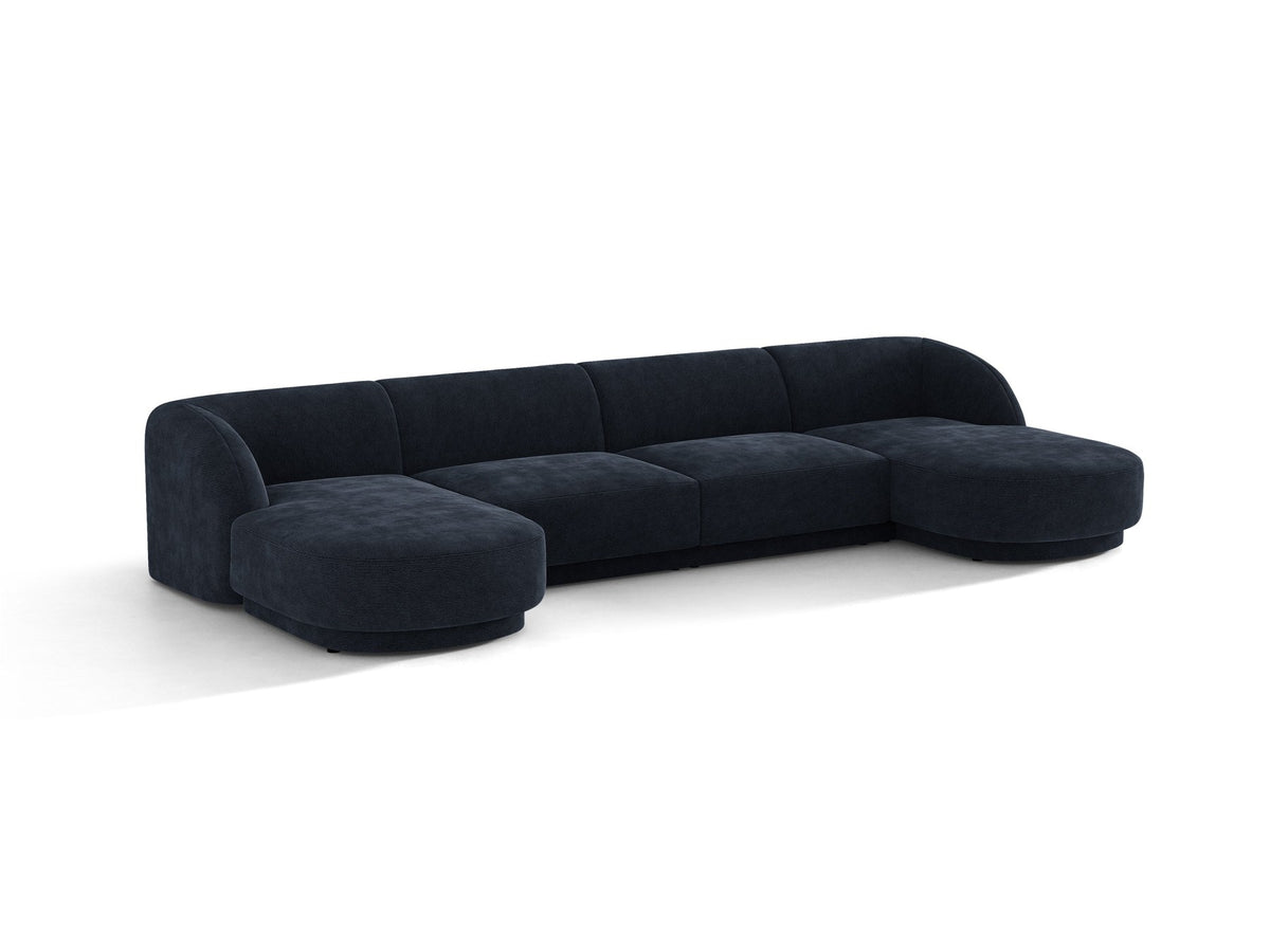 Dunkelbeiges Panorama-Ecksofa Miley von Micadoni mit Bluvel-Stoffbezug, L-Form, schwarzen Kunststoffbeinen und niedriger Rückenlehne.
