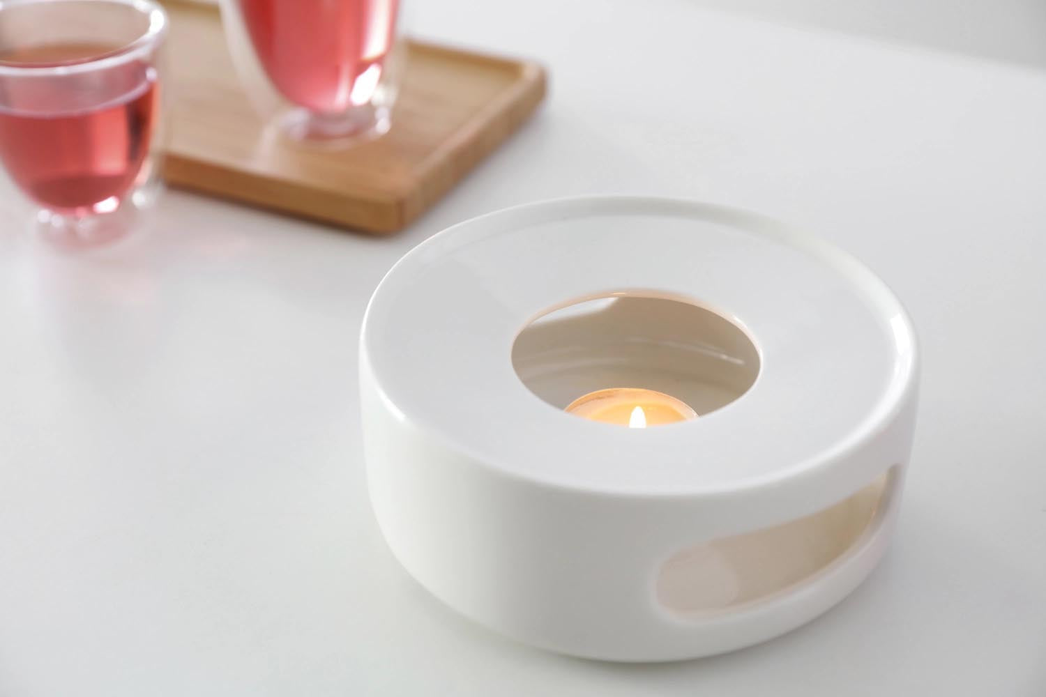 Elegantes Teestövchen aus weißem Porzellan, 14 cm breit, 5,6 cm hoch, minimalistisches Design, ideal für entspannte Teestunden.