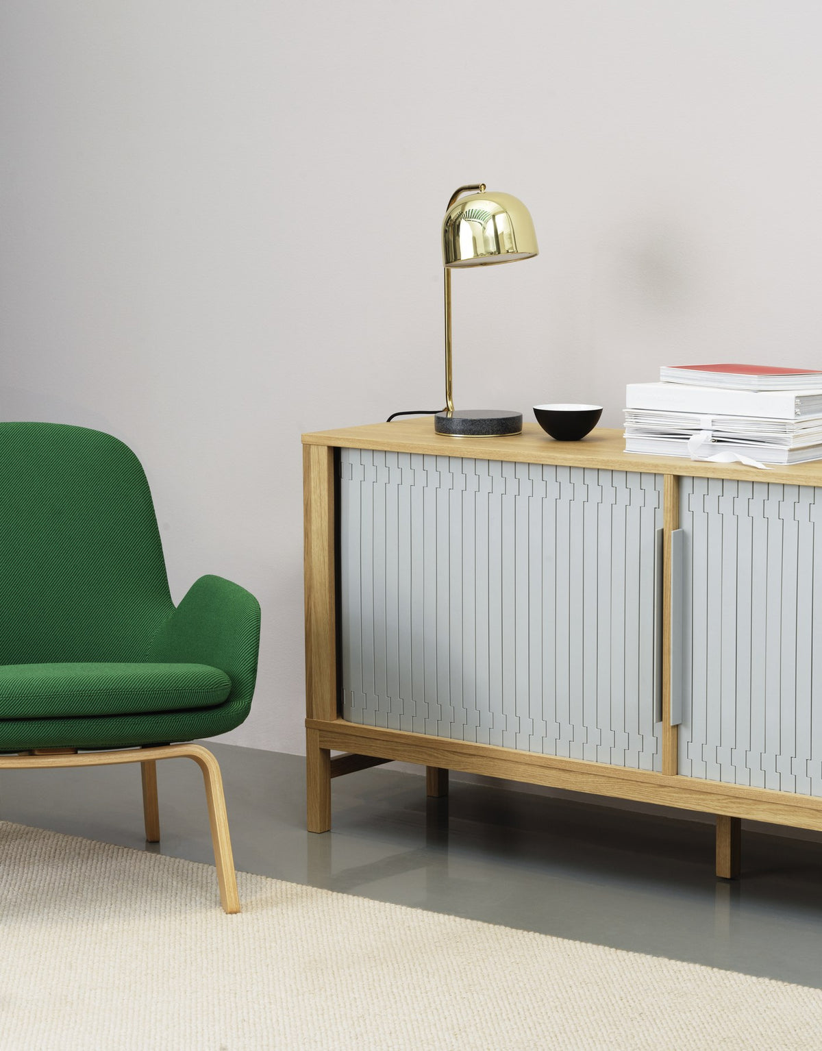 Era Lounge-Sessel von Normann Copenhagen in Grau mit gepolsterter Sitzschale und Beinen aus Walnussholz, geschwungene Form.