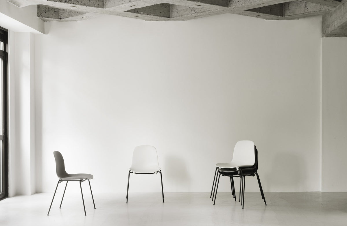 Form Stapelstuhl von Normann Copenhagen in Schwarz, gepolsterte Sitzschale aus Polypropylen auf vierbeinigem Gestell aus pulverbeschichtetem Stahl.