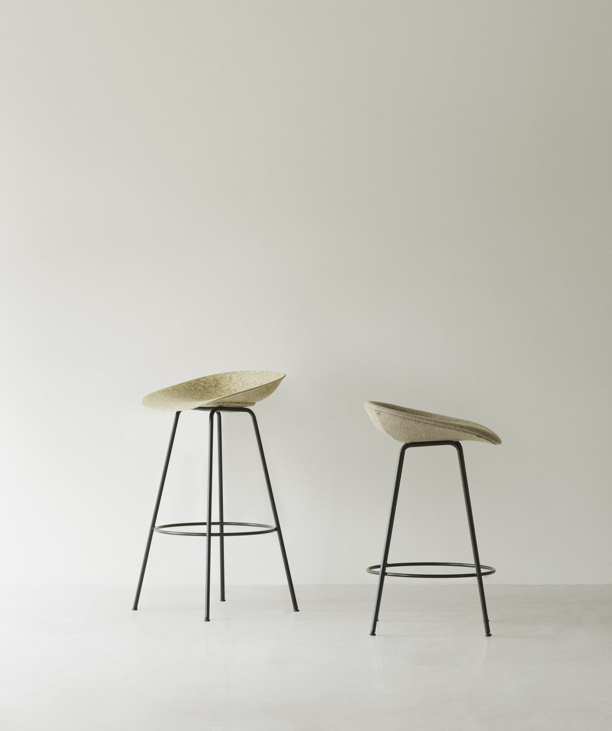 Foto des Barstuhls Mat von Normann Copenhagen: beige Sitzschale aus Hanf und Bindemittel, schwarzes Stahlgestell mit runden Beinen, Sitzhöhe 75 cm.