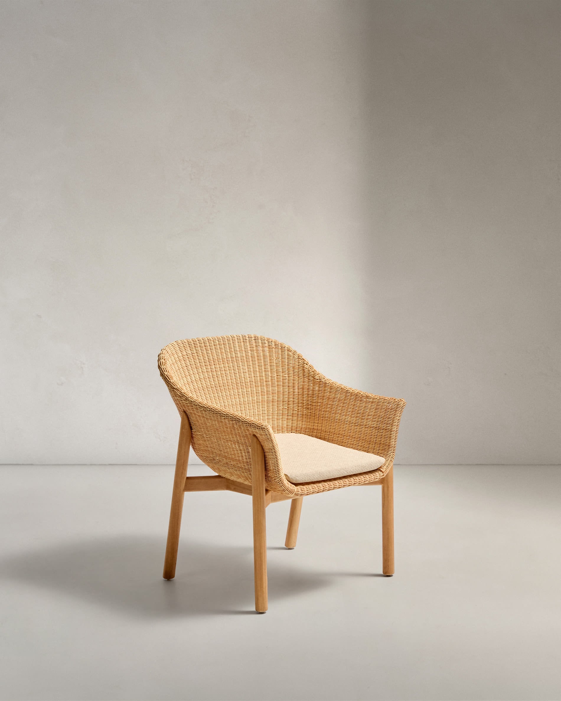 Der Stuhl Galea aus Teakholz und synthetischem Rattan vereint Eleganz, Beständigkeit und Komfort für Ihren Außenbereich.