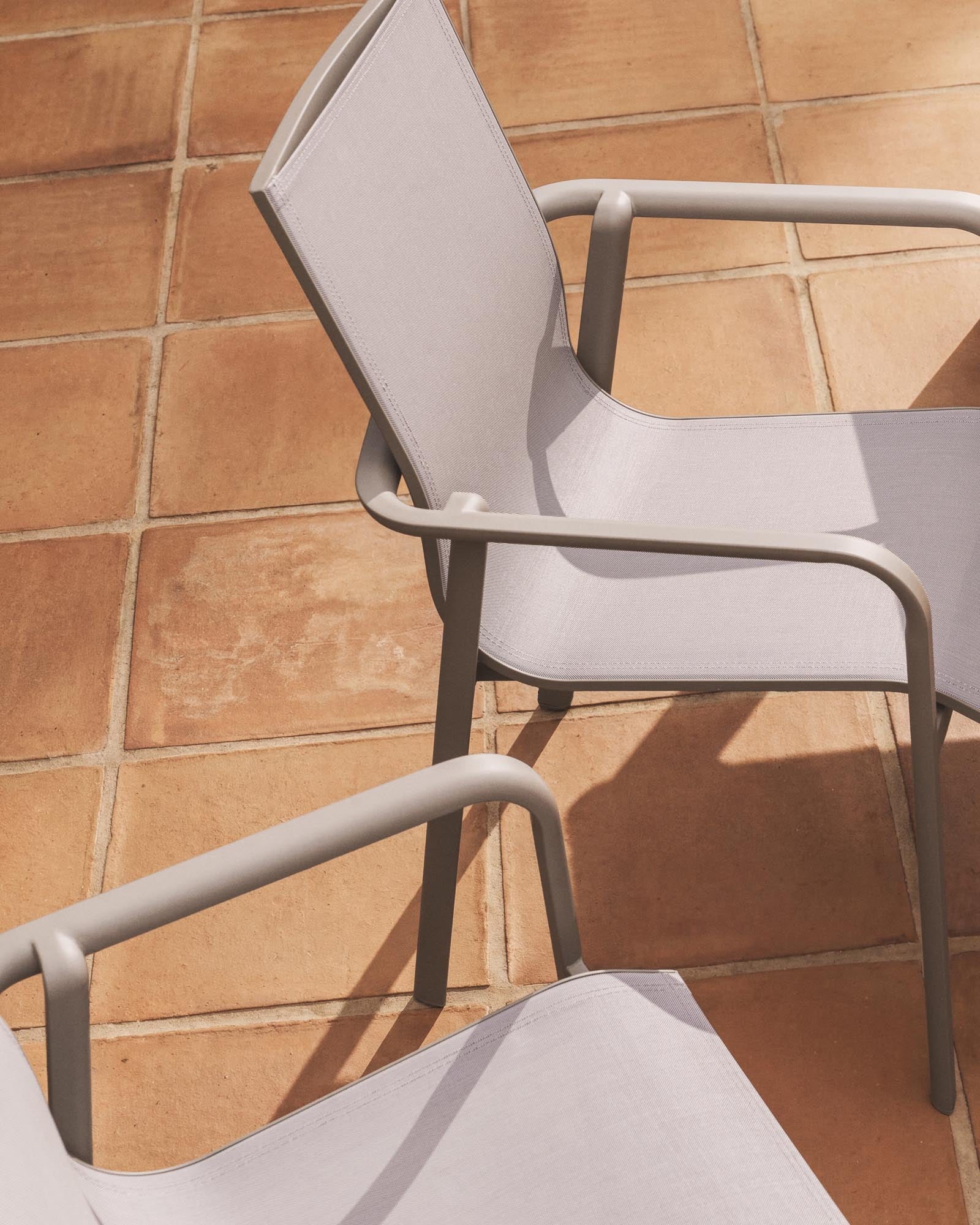 Stapelbarer Outdoor-Stuhl Canea aus beigem Texteline und Aluminium in Taupe in Taupe präsentiert im Onlineshop von KAQTU Design AG. Gartenstuhl mit Armlehnen ist von Kave Home