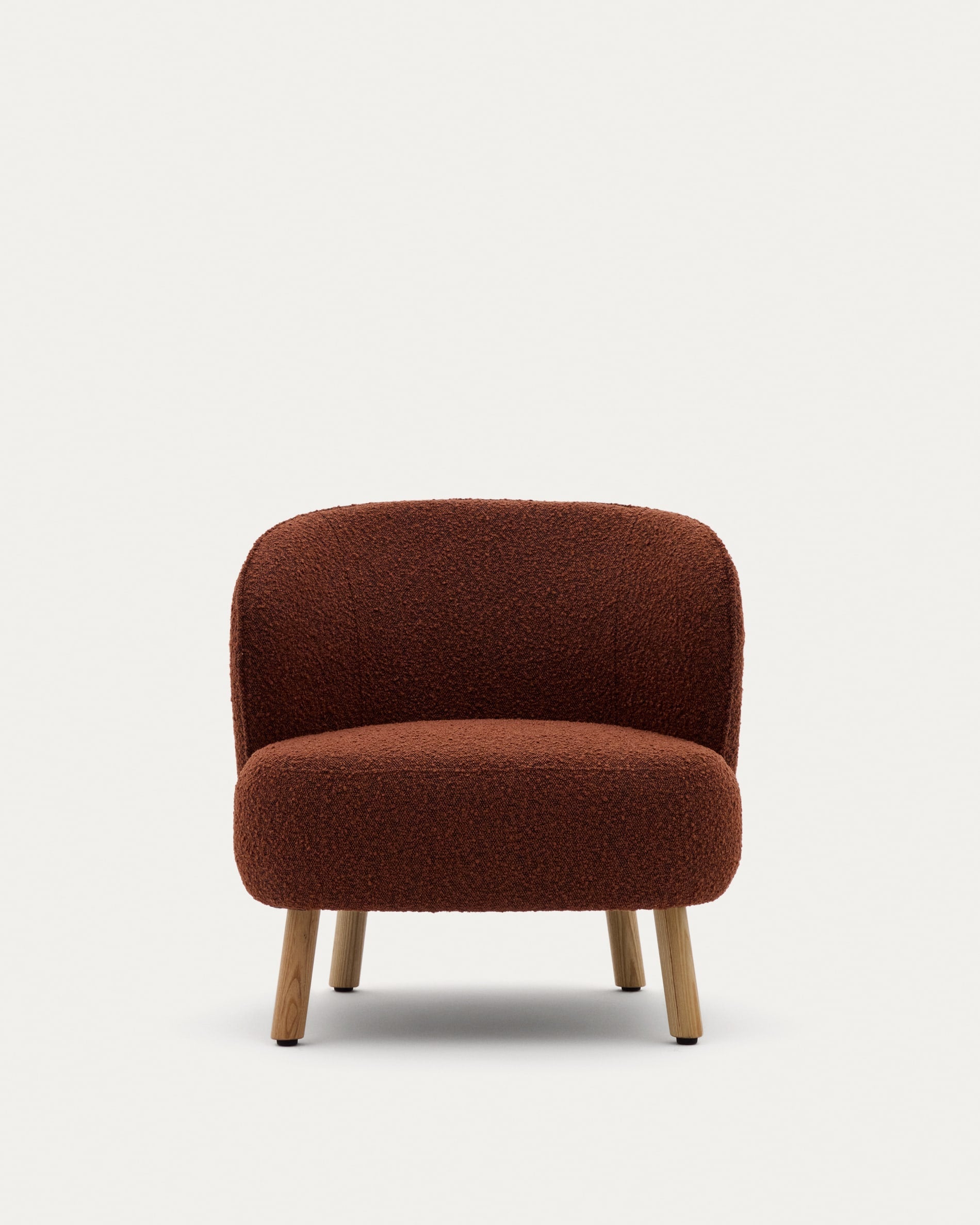 Sessel Ulit: Terrakottafarbenes Schaffell, massive Buchenholzbeine, natürliches Finish, stilvoll und perfekt für zeitgemäßes Interieur.