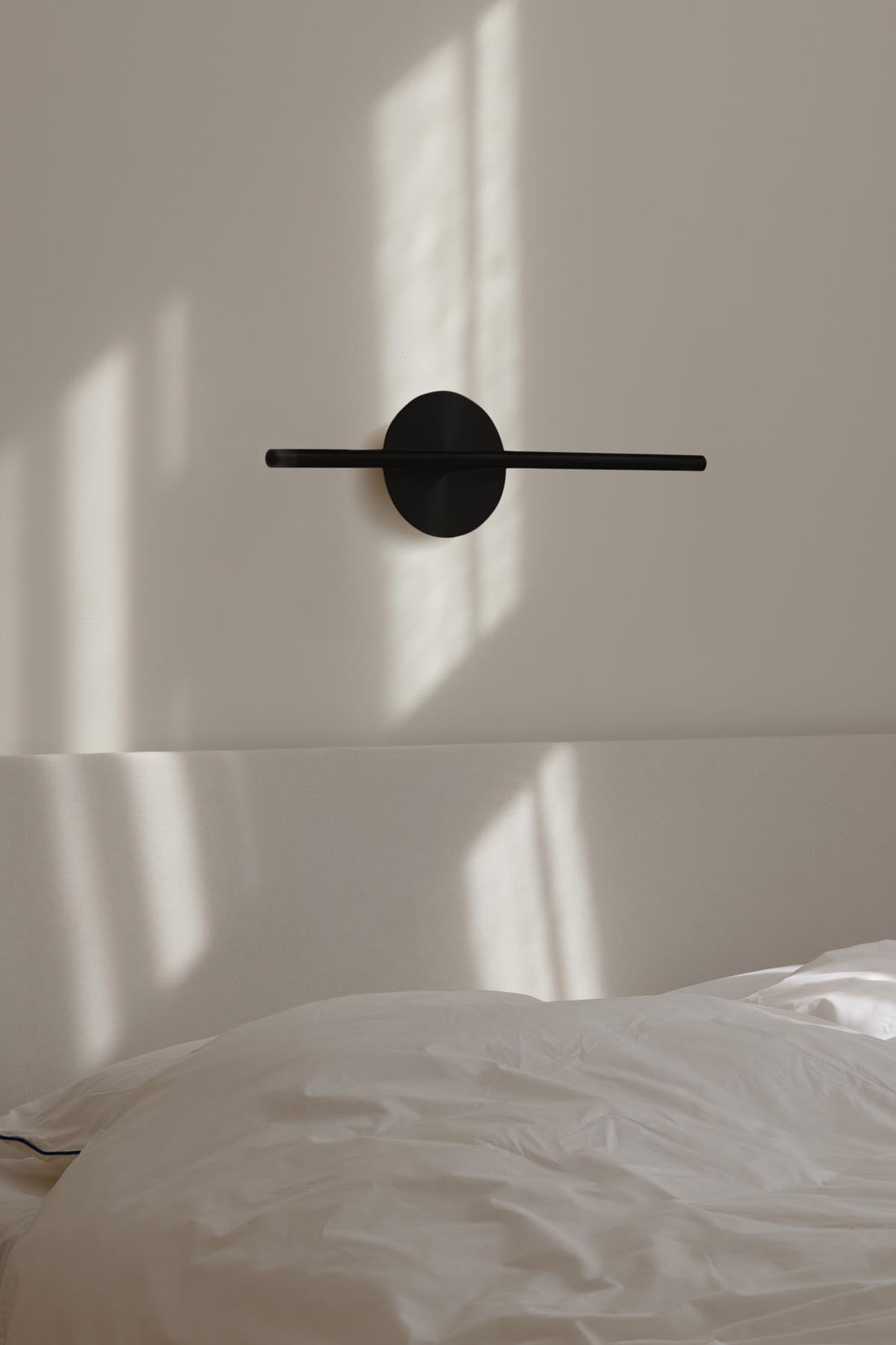 Moderne Omni Wall Wandleuchte von Umage in stilvollem Schwarz, ideal für eine gemütliche Atmosphäre und geschmackvolle Raumgestaltung.